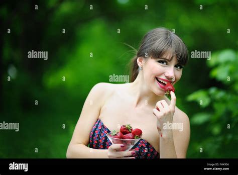 Beautiful Brunette Girl With Strawberry Stock Photo Alamy