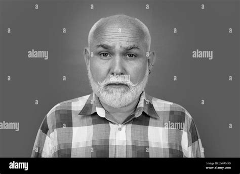 Closeup Emotional Portrait Of An Old Mature Senior Man With Grey Beard Isolated On Studio