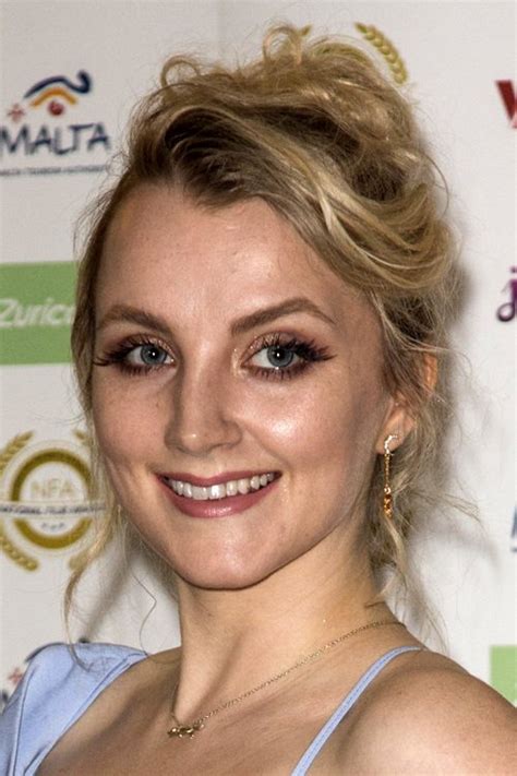 Evanna Lynch Wavy Platinum Blonde Dark Roots Updo Hairstyle Steal Her Style