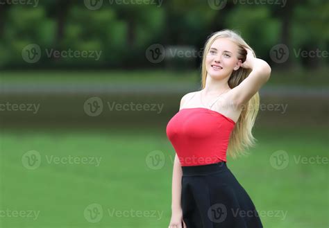 Beautiful Blonde Woman Standing While Listening Music On Headphone At Park 7111700 Stock Photo