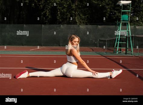 Fit Blonde Girl Does Front Leg Spirit Workout Exercise Outdoor Attractive Girl Trains Outside