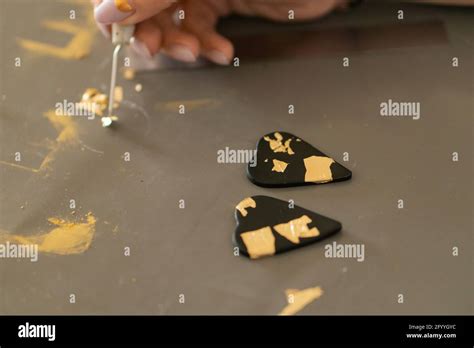 Gay Ethnic Male Wrapped In Rainbow Lgbt Flag Looking At Camera Against Gray Wall In City Stock