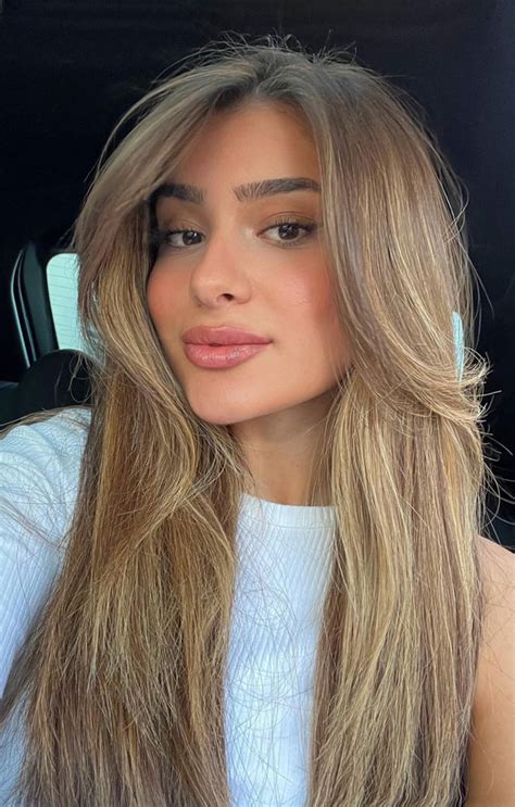 Exploring Chic Haircuts And Hair Trends Sleek And Straight Sandy Blonde With Curtain Bangs