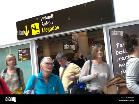 Airline passengers arriving at busy Lanzarote airport arrivals hall ...