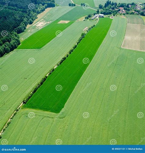 Aerial View Of Meadow In Road And Agriculture Fields With Forest Stock