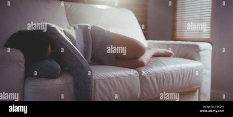 Brunette Sleeping On The Couch Stock Photo Alamy