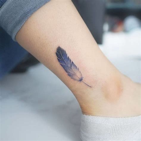 Blue feather tattoo on the ankle - Tattoogrid.net