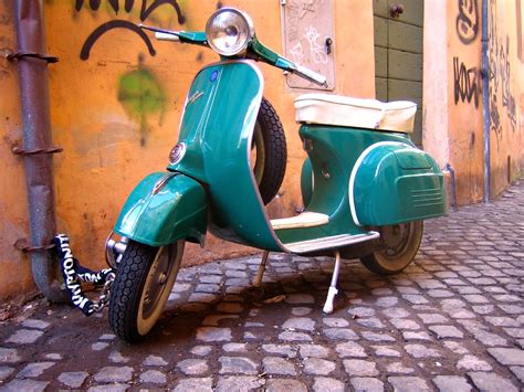 Vespa A Gorgeous Blue Vespa Against An Ochre Wall Anthony