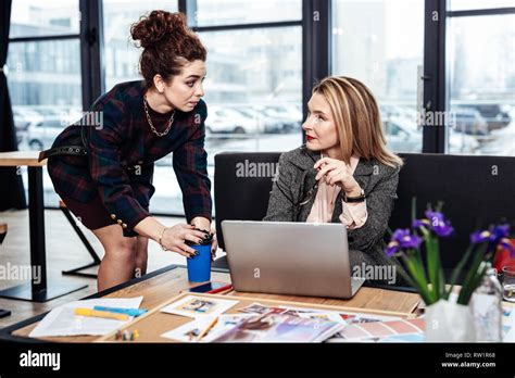 Curly Secretary Bringing Some Hot Coffee For Her Demanding Female Boss Stock Photo Alamy