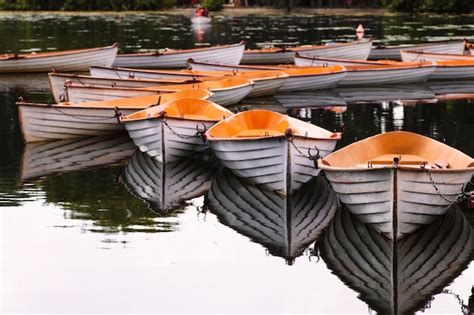 Premium Photo Row Of Boats Moored In Lake