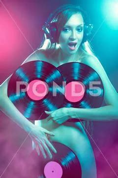 Naked Girl Dj With Headphones In Disco Light On Black Background Stock Photo