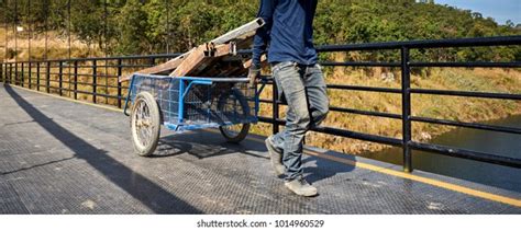 Worker Hauling Cart On Suspension Bridge Stock Photo 1014960529