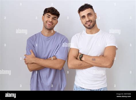 Homosexual Gay Couple Standing Over White Background Happy Face Smiling With Crossed Arms