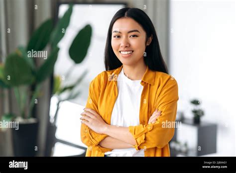 Portrait Of A Lovely Positive Brunette Modern Brown Eyed Girl Asian Nationality Wearing Casual