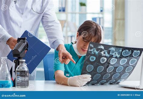 Two Doctors Discussing X Ray MRI Image In Hospital Stock Image Image