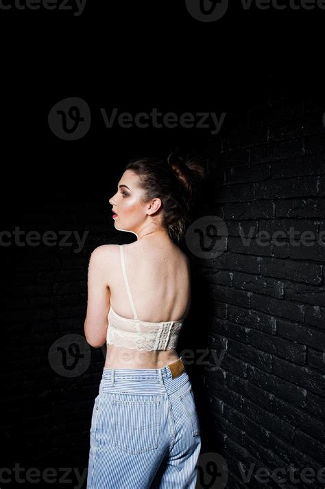 Stylish Brunette Girl On Bra Against Studio Black Brick Wall 10500492 Stock Photo At Vecteezy