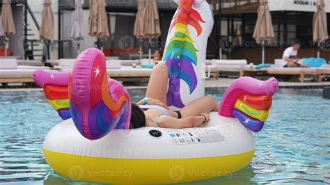Woman In Bikini In Inflatable Unicorn Toy Mattress Float In Pool Stock Photo At Vecteezy