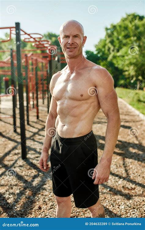 Athletic Mature Man Bodybuilder With Naked Torso Smiling At Camera