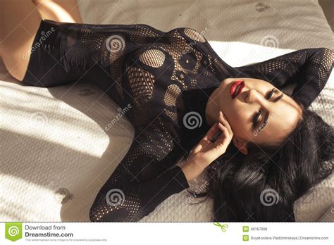 Beautiful Woman With Dark Hair In Black Lingerie Lying On Bed Stock Photo Image Of Luxurious
