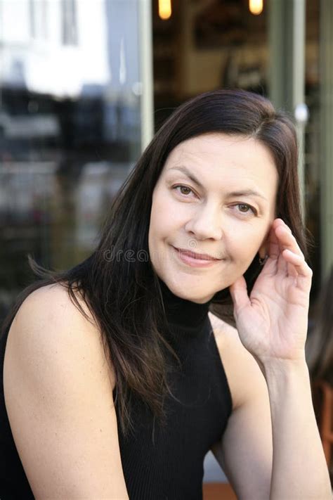 Smiling Satisfied Brunette Woman Middle Aged 51 Years Old Relaxing In A Cafe And Posing For The