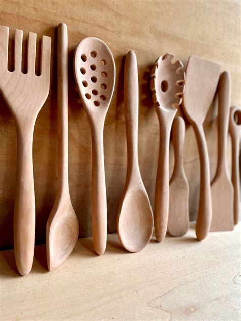 Wooden Spoons And Spatulas Lined Up On A Wall