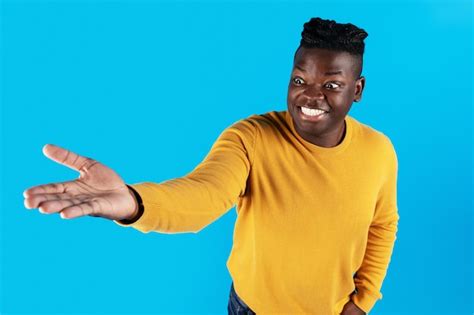 Premium Photo Excited African American Man Outstretching Hand Holding