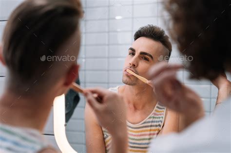 Gay Couple Cleaning His Teeth With A Sustainable Bamboo Toothbrush Stock Photo By Edufigueres