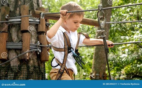 portrait  brave boy walking  obstacles  rope park  forest