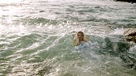 Blonde Woman Runs Into Sea Splashes In Waves In Sunset Light Female In Dress Enjoys Freedom