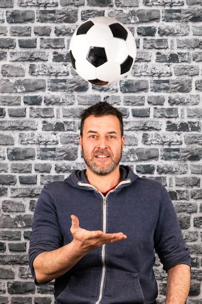 Premium Photo Portrait Of Smiling Man Playing With Soccer Ball