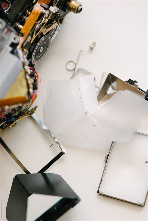 broken camera laying   side parts scattered  stocksy