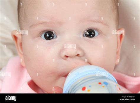 Feeding four month old baby girl Stock Photo - Alamy