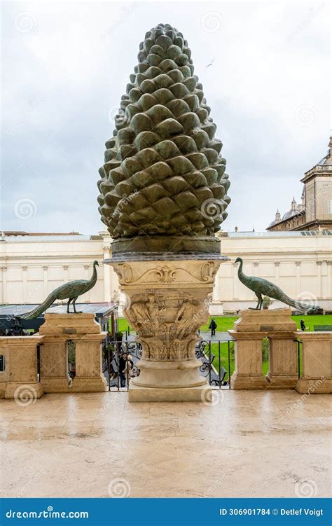 intricately carved stone pinecone statue flanked   peacocks