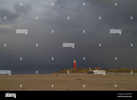 Lighthouse Rain Clouds And Wide Beach Stock Photo Alamy