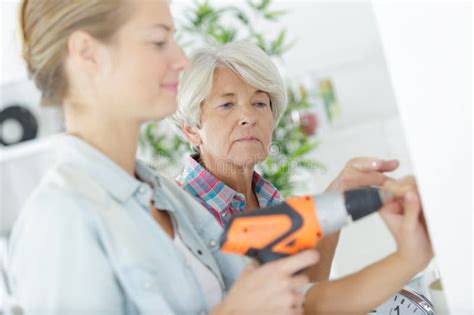 Smiling Blonde Granddaughter With Grandmother Stock Image Image Of Interior Tool