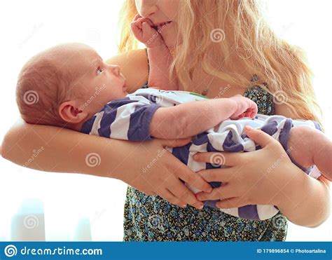 Loving Older Sister Blonde Sweetheart Touching And Gentle Holds Her Newborn Brother In Her Arms
