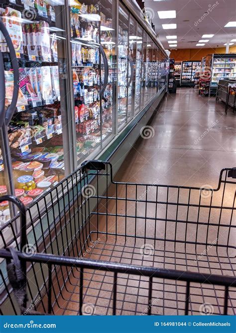 Partial View of a Shopping Cart As it Navigates through a QFC Grocery