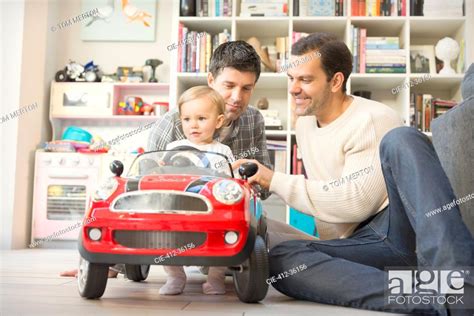 Male Gay Parents And Baby Son Playing With Toy Car Stock Photo Picture And Royalty Free Image