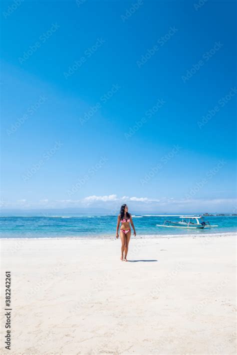A Beautiful Asian Woman Solo Traveller In A Bikini On A Pristine Tropical Beach Bali Indonesia