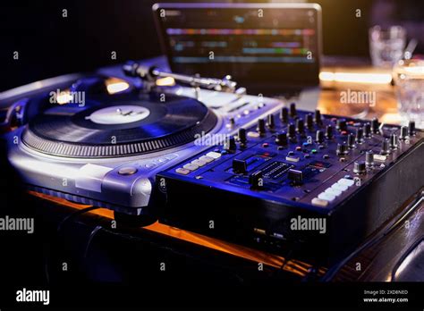 Club DJ mixing music set. DJ Spinning, Mixing, and Scratching in a ...