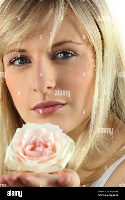 Blonde Woman With Rose In Hand Stock Photo Alamy