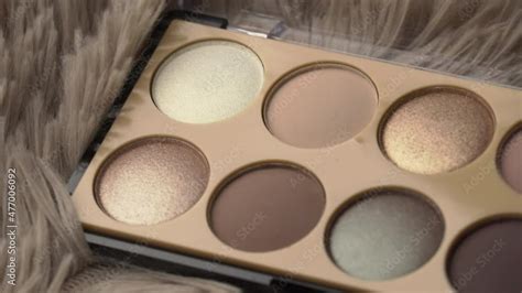 Glitter Eye Shadow Swirls Against A Black Background New Untouched Cosmetics In A Nude Color