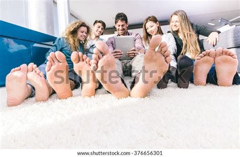 Group Of Friends Having Fun And Spending Time Together At Home Focus On The Naked Feet