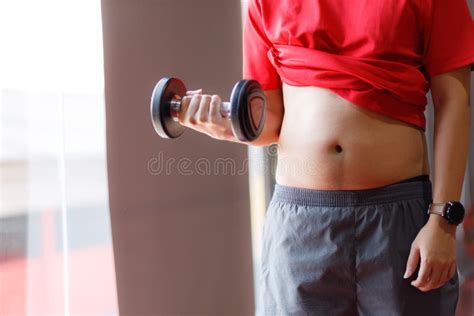 Fat Man Obese Man Hand Holding Excessive Belly Fat On Gym Background