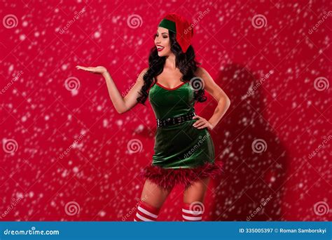 Photo Of Provocative Babe Palm Demonstrate Empty Space Option Wear Hat Elf Costume Isolated Red