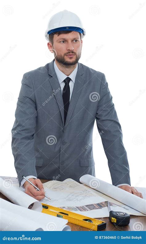 Mature Male Architect Thinking While Working On A Blueprint Stock Photo