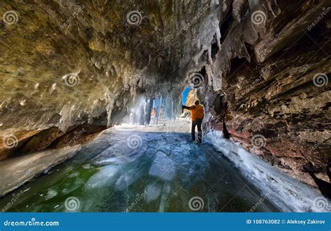 Panorama Man In An Ice Cave With Icicles On Baikal Olkhon Stock Photo
