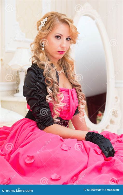 Stylish Blonde In Long Red Dress Is Sitting On Bed Stock Photo Image Of Casual Gorgeous 61360400