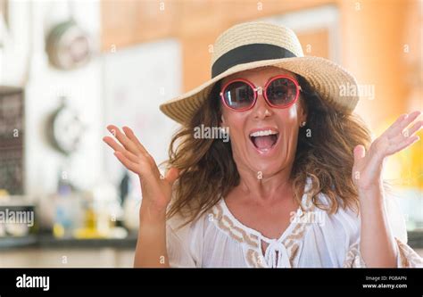 Middle Age Brunette Woman Wearing Summer Hat On Vacations Very Happy And Excited Winner