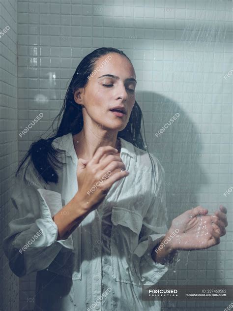 Woman Dressed Wet Standing In Shower Under Spraying Water Depressed Brunette Stock Photo